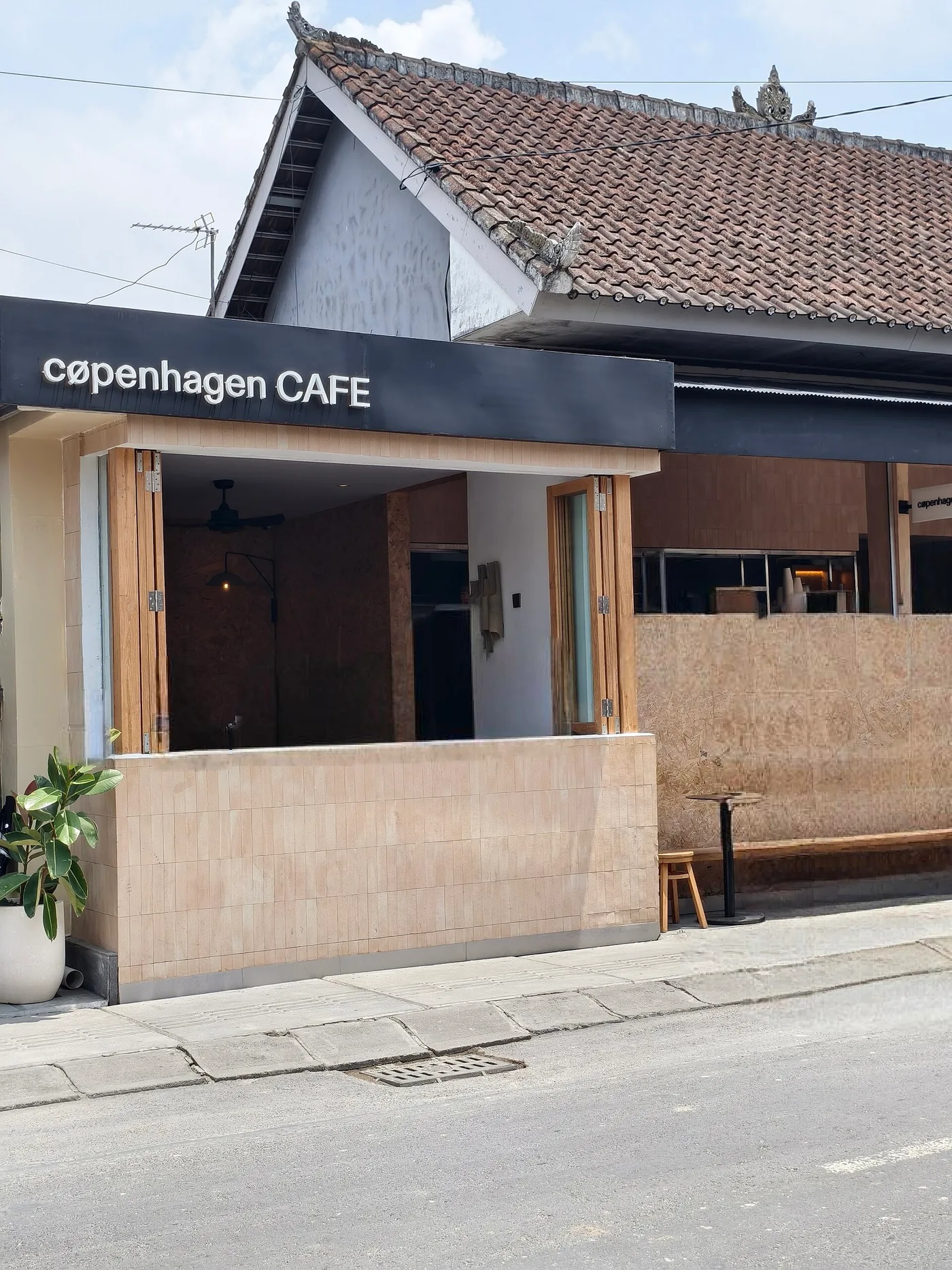 The open, folding-door street frontage of a café in Canggu, Bali