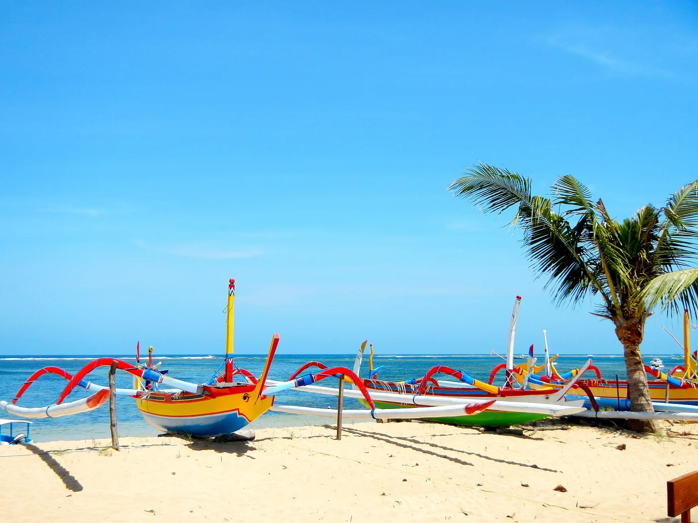 Colourful traditional jukung outrigger boats on the sand at Sanur