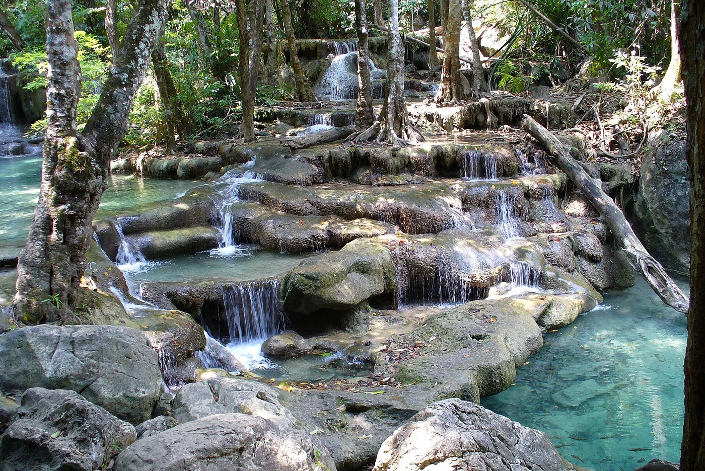 The tiered turquoise limestone pools of Erawan Falls, Kanchanaburi