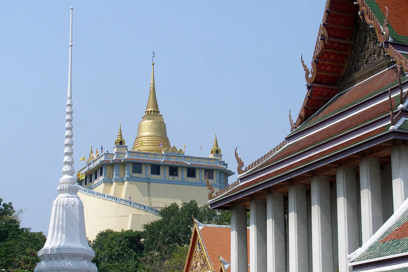 The golden chedi of the Golden Mount temple rising over old-city rooftops in Bangkok