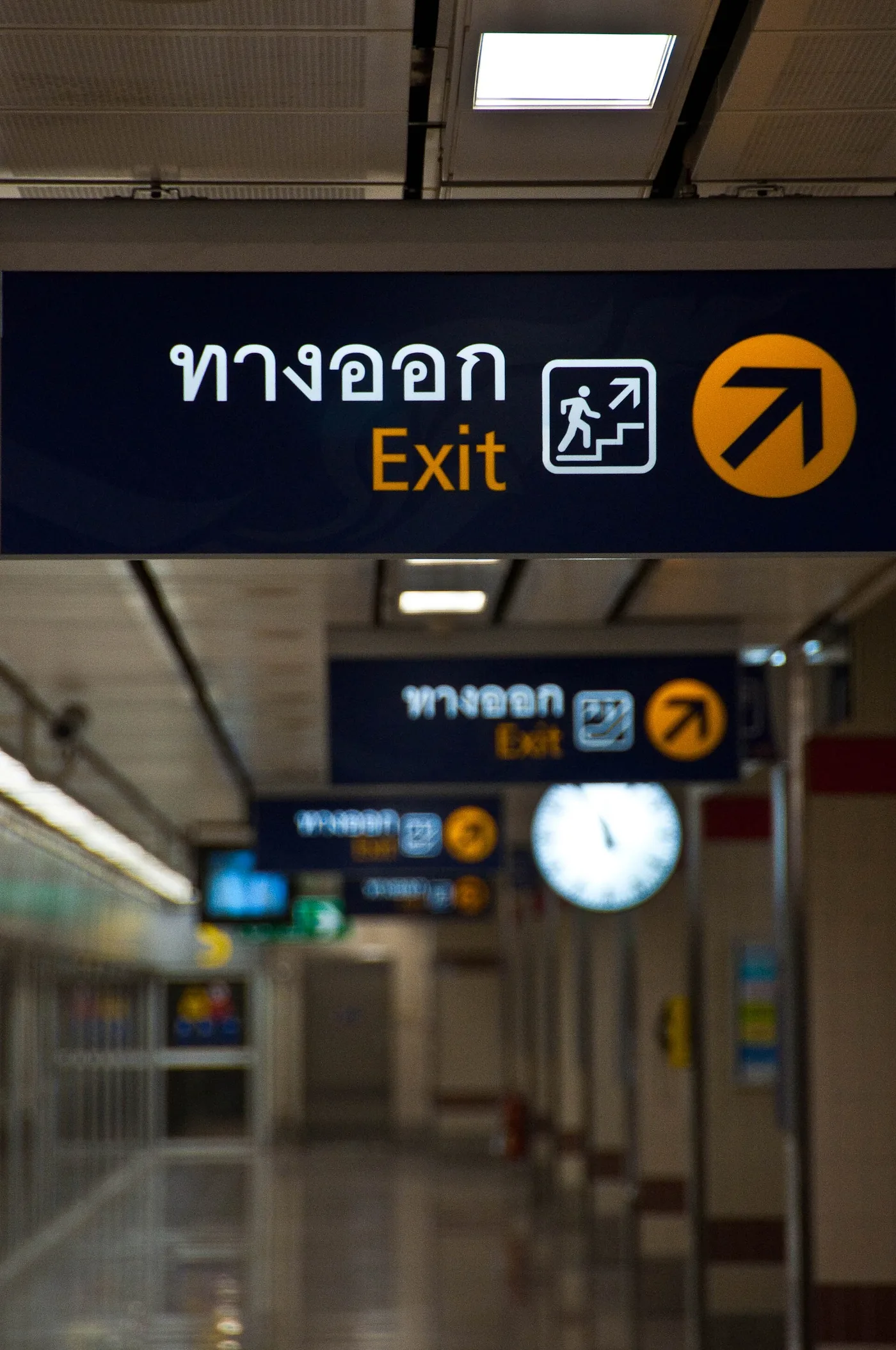 An exit sign and corridor inside a Bangkok MRT subway station