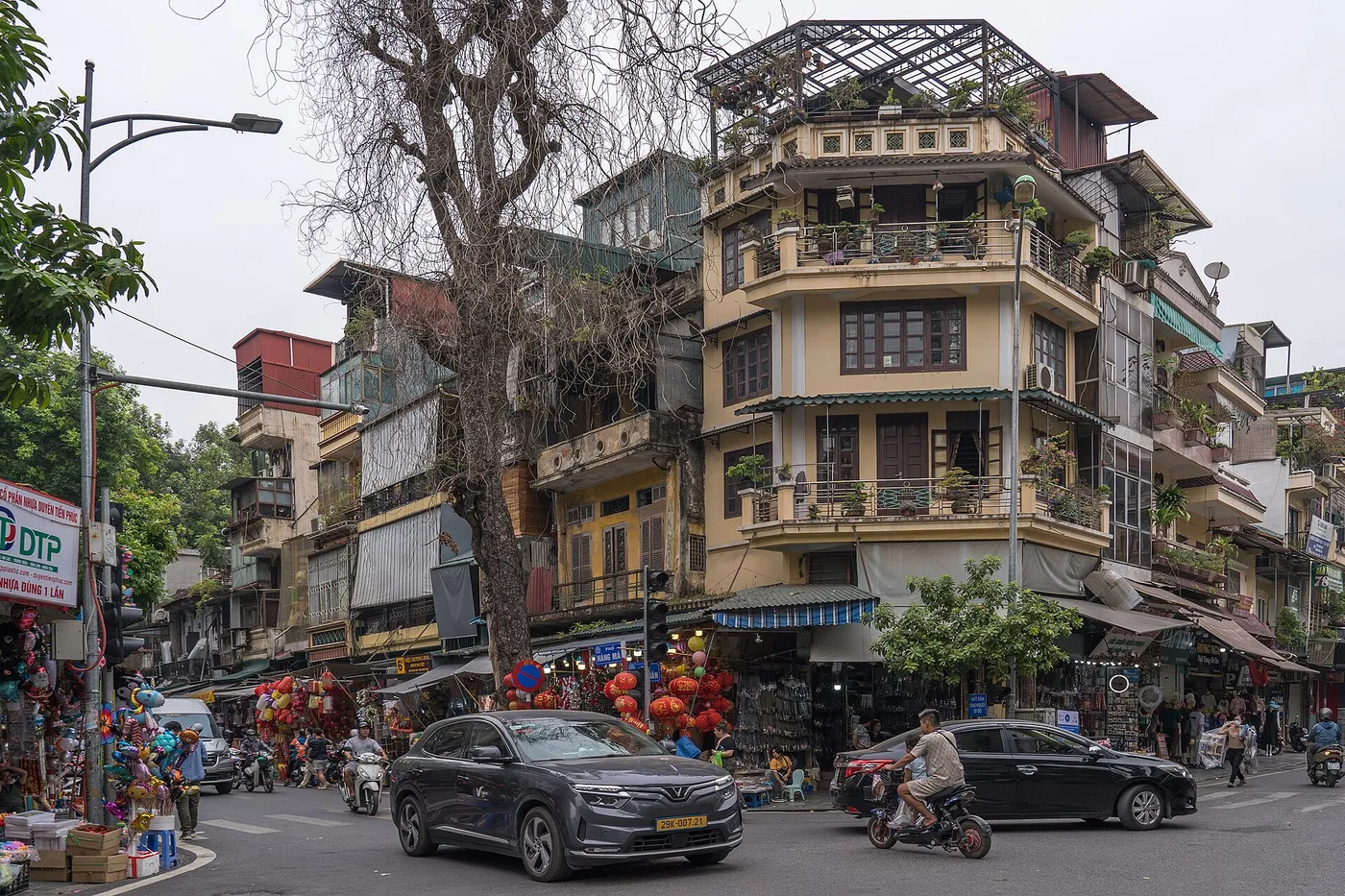A street corner in Hanoi's Old Quarter with its ochre corner building and lantern shops