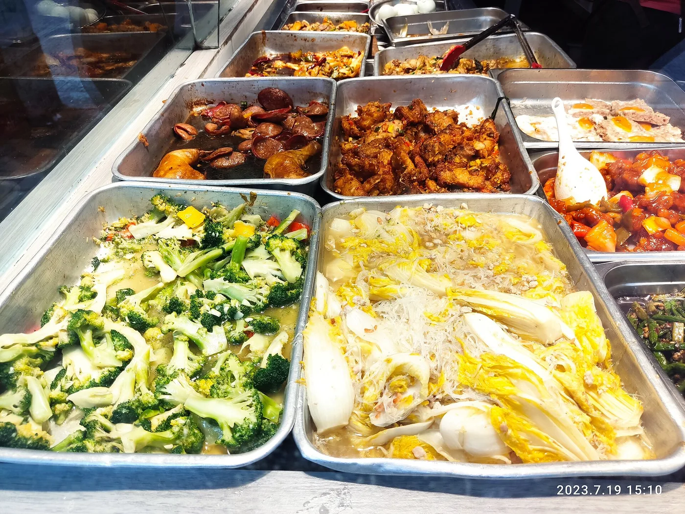 A Sham Shui Po street-food stall with trays of cooked dishes