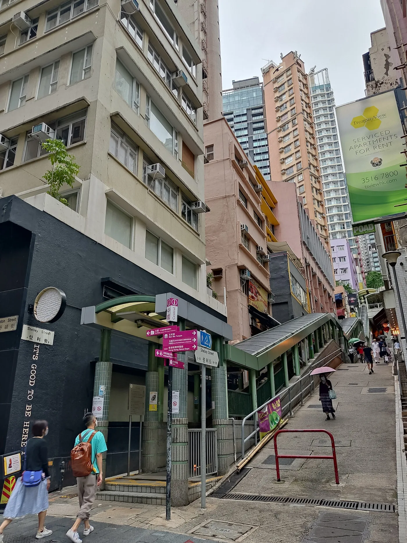 The covered Central–Mid-Levels escalator climbing a steep SoHo street