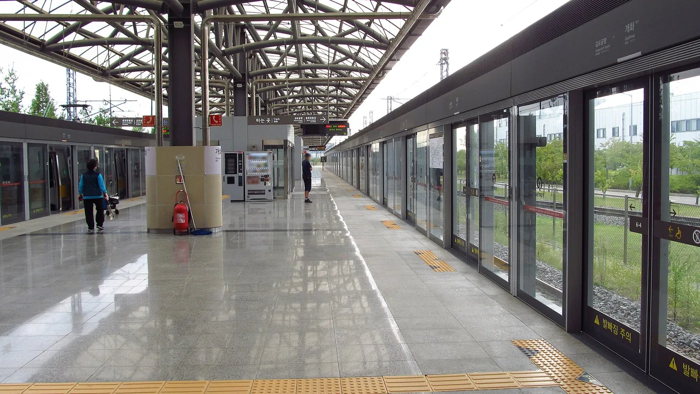 A clean, modern Seoul Metro platform with platform screen doors and bilingual signage