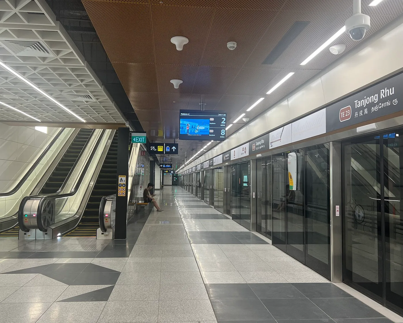 A spotless, near-empty Singapore MRT platform with platform-screen doors