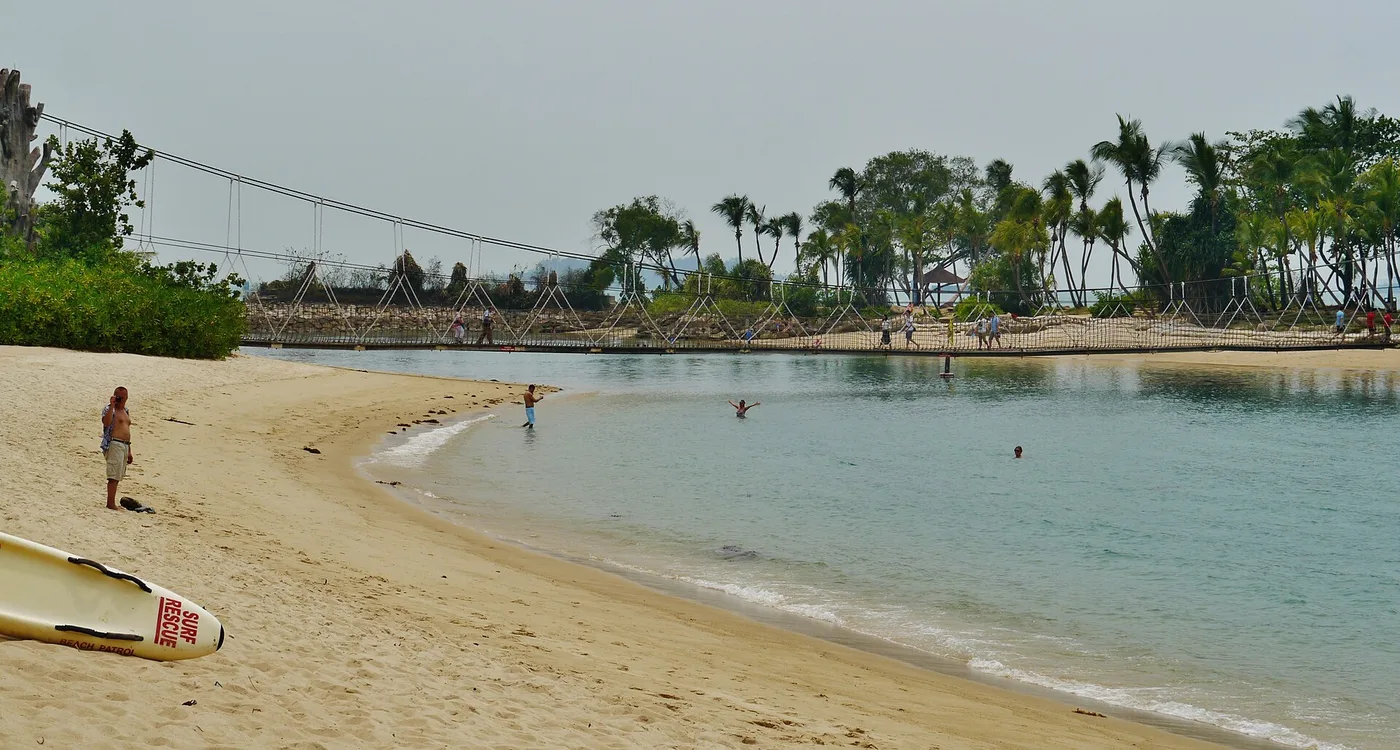 Palawan Beach on Sentosa — the rope suspension bridge to the palm-covered islet