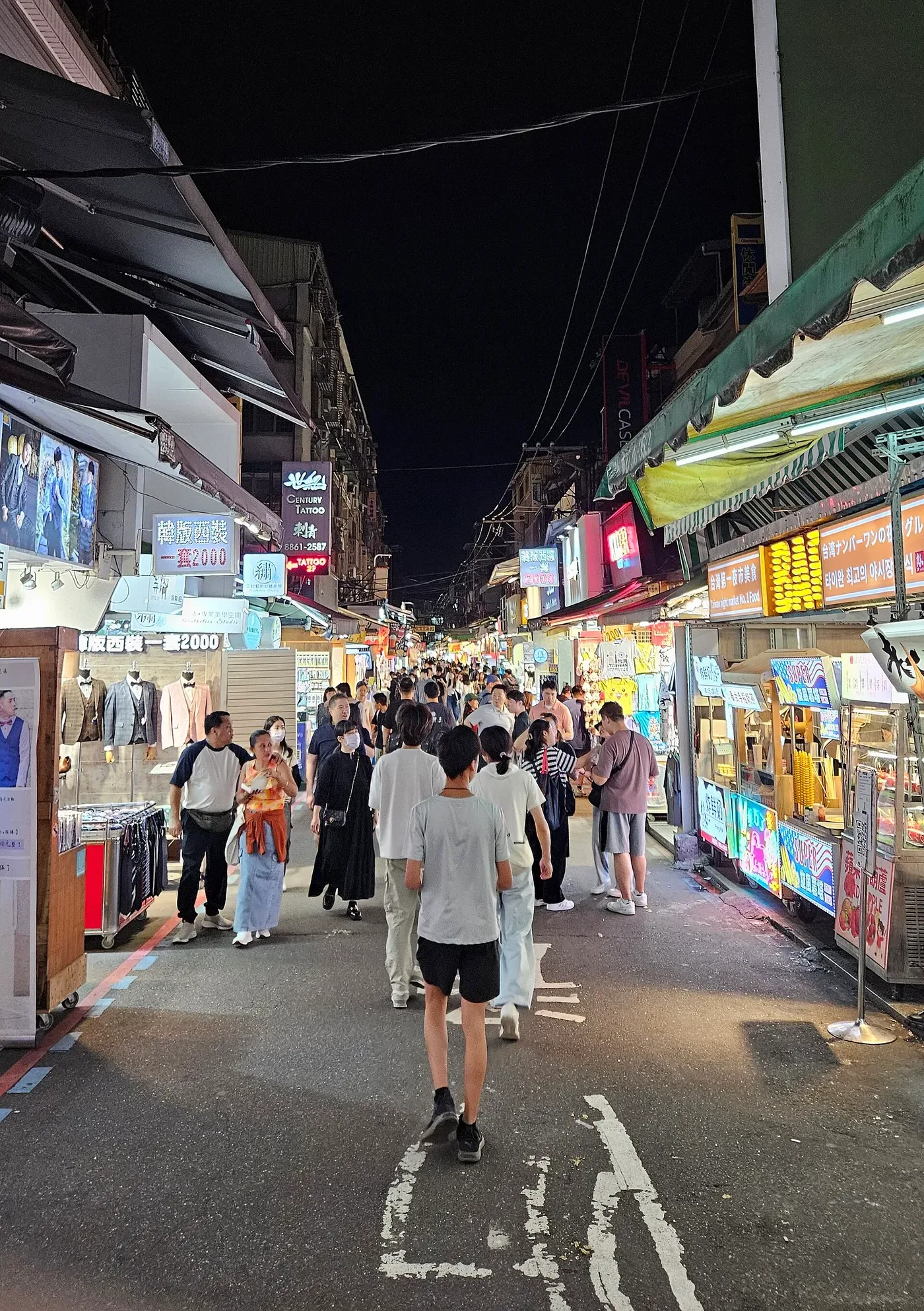 Crowds down a food-stall street at Taipei's Shilin Night Market at night
