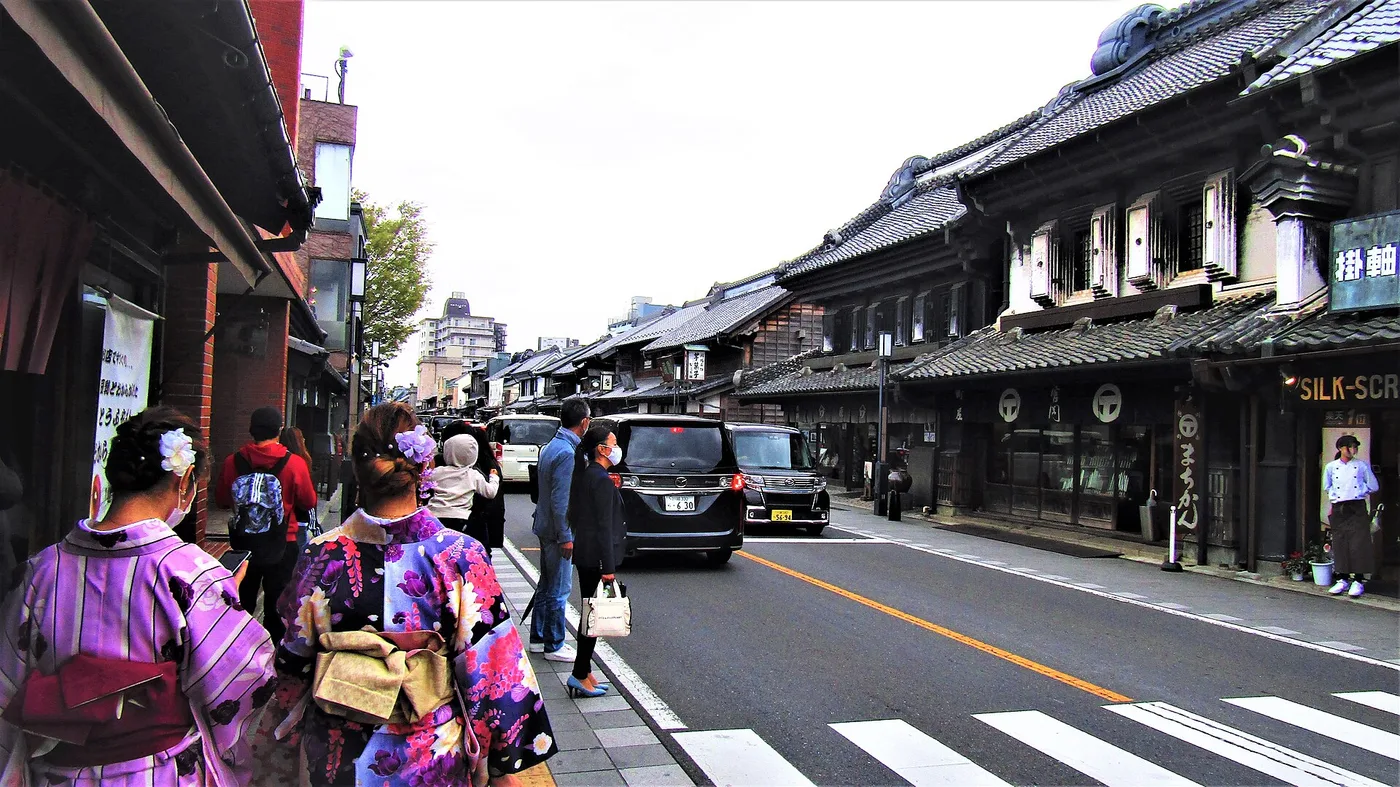 Kawagoe's kurazukuri clay-warehouse street, with kimono-clad visitors seen from behind