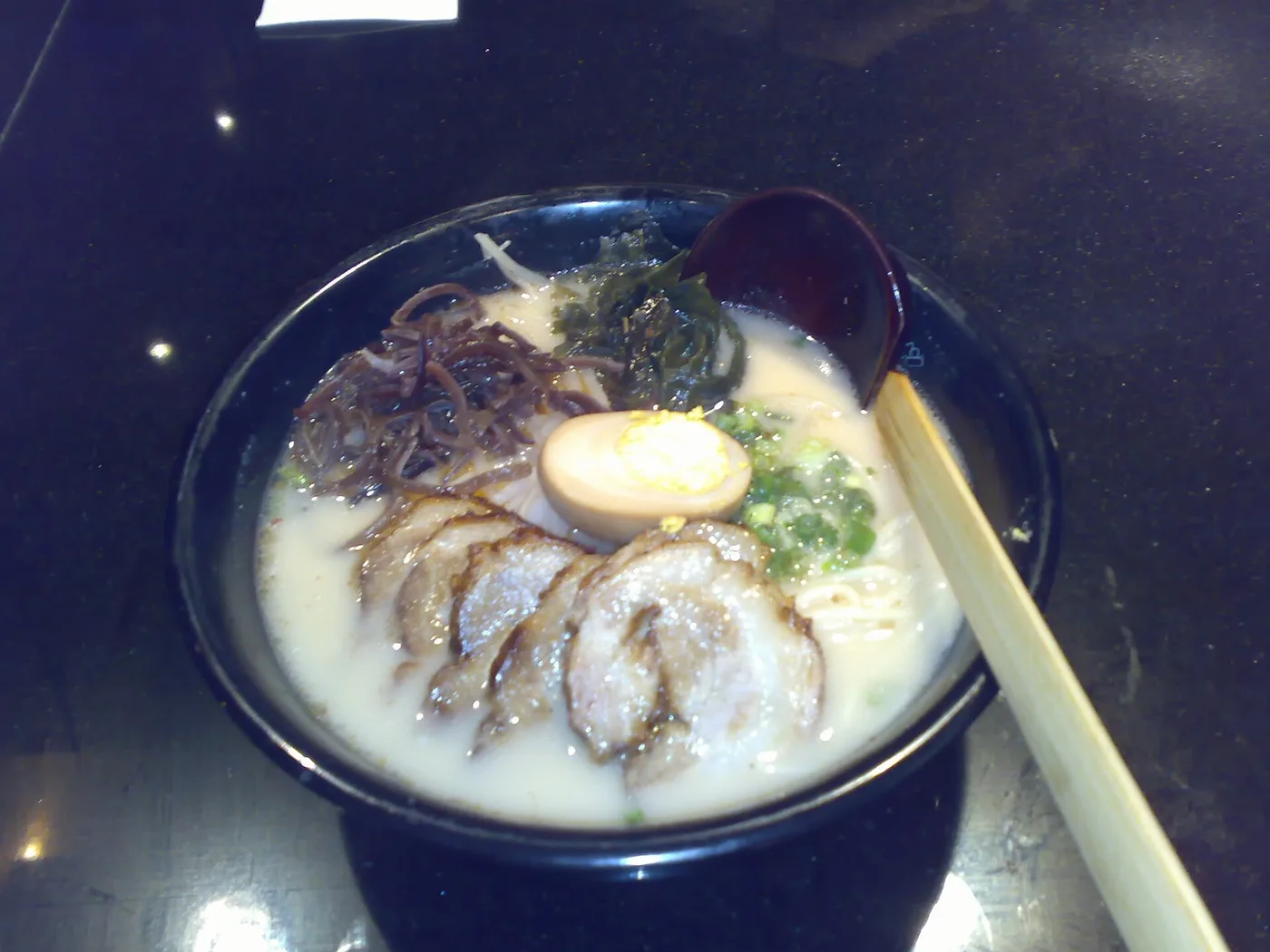 A bowl of tonkotsu ramen with chāshū, egg and scallion