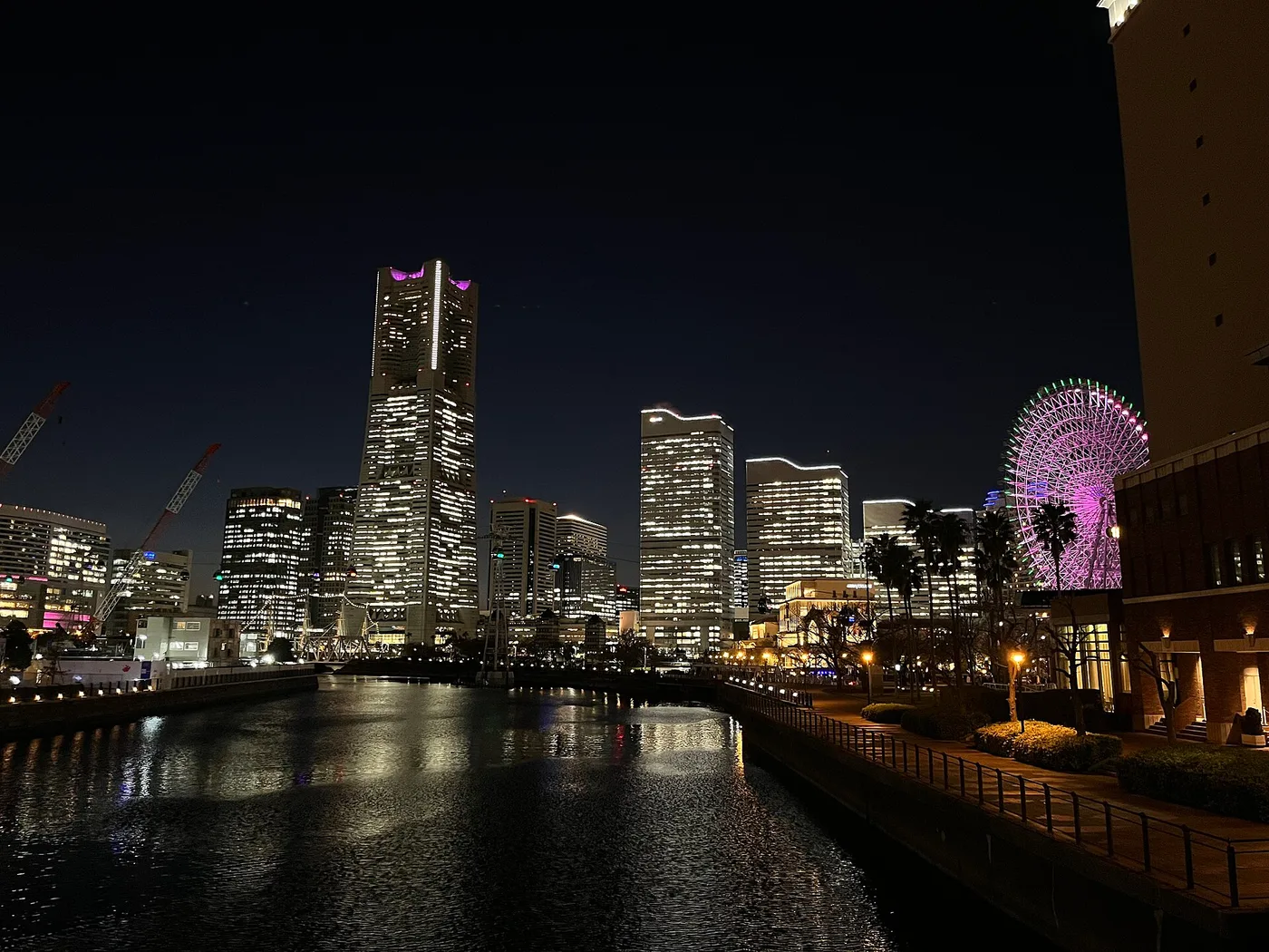 Yokohama's Minato Mirai waterfront at night — the Landmark Tower and the lit Ferris wheel